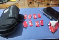 Barang Bukti delapan paket yang dibungkus lakban merah bertuliskan 